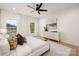 Sunlit bedroom boasts a large window, plush bedding, decorative lighting, and an artful dresser at 15906 Youngblood Rd, Charlotte, NC 28278