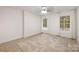 Bright bedroom with a ceiling fan and large windows that provide natural light and views at 15906 Youngblood Rd, Charlotte, NC 28278