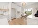 Cozy breakfast nook with white cabinets, open shelves, and a view of the outdoors at 15906 Youngblood Rd, Charlotte, NC 28278