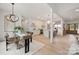 Open concept dining area with modern chandelier, glass top table, and views into the kitchen at 15906 Youngblood Rd, Charlotte, NC 28278