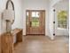 Bright foyer with light hardwood floors, a stylish console table, and a view of the front yard at 15906 Youngblood Rd, Charlotte, NC 28278