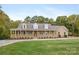 Charming brick home featuring a welcoming porch, dormer windows, and a beautifully landscaped front yard at 15906 Youngblood Rd, Charlotte, NC 28278