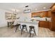 Well-appointed kitchen with warm wood cabinets, a central island, and adjacent dining space at 15906 Youngblood Rd, Charlotte, NC 28278