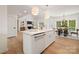 Bright kitchen with a center island, stainless steel appliances, and an open layout to the dining area at 15906 Youngblood Rd, Charlotte, NC 28278