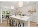Bright kitchen with a large island, pendant lights, and open concept design to the dining room at 15906 Youngblood Rd, Charlotte, NC 28278