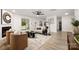 Open living room with a fireplace, modern decor, and lots of natural light at 15906 Youngblood Rd, Charlotte, NC 28278