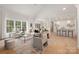 Bright living room with large windows, hardwood floors, and an open layout flowing into the kitchen and dining area at 15906 Youngblood Rd, Charlotte, NC 28278