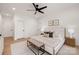Bright bedroom features modern ceiling fan, a large bed with bench seating, and recessed lighting at 15906 Youngblood Rd, Charlotte, NC 28278