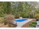 Sparkling blue in-ground pool surrounded by a concrete patio and lush greenery at 15906 Youngblood Rd, Charlotte, NC 28278