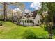Spacious backyard featuring a patio with outdoor seating, lush green grass, and mature trees at 16 Catawba Ridge Ct, Clover, SC 29710
