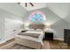 Bedroom showcases a stained glass window above the bed, complemented by neutral walls and hardwood floors at 16 Catawba Ridge Ct, Clover, SC 29710