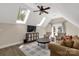 Cozy upstairs living area with vaulted ceilings, skylights, and french doors to an outdoor balcony at 16 Catawba Ridge Ct, Clover, SC 29710