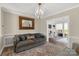 Inviting sitting area featuring a large sofa with accent pillows and a sunroom extension beyond at 16 Catawba Ridge Ct, Clover, SC 29710