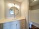A bathroom with a single sink, a mirror, and a shower and bathtub at 16149 Haroa Ct, Tega Cay, SC 29708