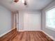 Bedroom features wood floors and large closet at 16149 Haroa Ct, Tega Cay, SC 29708