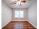 This bedroom features wood flooring, a ceiling fan, and large closet at 16149 Haroa Ct, Tega Cay, SC 29708