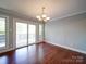 Bright dining area features hardwood floors and a sliding glass door to the back deck at 16149 Haroa Ct, Tega Cay, SC 29708
