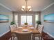 Elegant dining room with hardwood floors, a modern chandelier, and a sliding glass door at 16149 Haroa Ct, Tega Cay, SC 29708