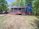Large blue home with a deck and a grassy yard at 16149 Haroa Ct, Tega Cay, SC 29708