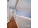 Bright upstairs hallway with wood flooring leading to rooms at 16149 Haroa Ct, Tega Cay, SC 29708