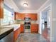 Well-lit kitchen features stainless steel appliances and a large farmhouse sink at 16149 Haroa Ct, Tega Cay, SC 29708