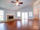 Spacious living room with hardwood floors, a stone fireplace, and lots of natural light at 16149 Haroa Ct, Tega Cay, SC 29708