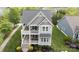 Aerial view of a well-maintained two-story home with double porches and a landscaped yard at 19034 Cypress Garden Dr, Davidson, NC 28036