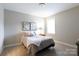 Neutral bedroom featuring a comfy bed with soft bedding, soft carpet, neutral walls and two botanical prints at 19034 Cypress Garden Dr, Davidson, NC 28036
