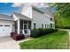 This home features a screened porch, attached garage and manicured landscaping at 19034 Cypress Garden Dr, Davidson, NC 28036