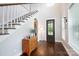 Bright foyer with hardwood floors, staircase, and natural light, creating a welcoming entrance at 19034 Cypress Garden Dr, Davidson, NC 28036
