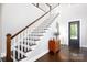 Light-filled foyer features hardwood floors, a staircase, and an arched doorway to another room at 19034 Cypress Garden Dr, Davidson, NC 28036