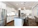 Modern kitchen with stainless steel appliances, a center island, and white cabinetry at 19034 Cypress Garden Dr, Davidson, NC 28036