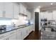 Bright kitchen with stainless steel appliances, white cabinetry, and tile backsplash at 19034 Cypress Garden Dr, Davidson, NC 28036