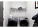 Laundry room with new front loading Samsung washer and dryer and wire shelving above at 19034 Cypress Garden Dr, Davidson, NC 28036