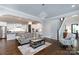 Open-concept living room with hardwood floors and staircase, connected to the kitchen at 19034 Cypress Garden Dr, Davidson, NC 28036