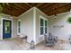Charming porch with wooden floors, stylish light fixtures, and comfortable seating at 19034 Cypress Garden Dr, Davidson, NC 28036