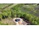 Expansive aerial shot of a modern home surrounded by lush trees and verdant fields on a sprawling lot at 2008 Plain Field Dr, Bessemer City, NC 28016