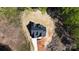 Stunning aerial view of a new home featuring a dark roof and a concrete driveway nestled amongst trees at 2008 Plain Field Dr, Bessemer City, NC 28016