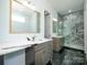 Bathroom featuring marble countertops, dual vanities, and a luxurious marble shower at 2008 Plain Field Dr, Bessemer City, NC 28016