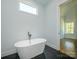 Modern bathroom featuring a freestanding tub and black marble tile floors at 2008 Plain Field Dr, Bessemer City, NC 28016