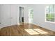 Sunlit bedroom with hardwood floors, white trim, two windows, and a closet at 2008 Plain Field Dr, Bessemer City, NC 28016