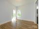 Light-filled bedroom with hardwood floors, two windows, and neutral wall paint at 2008 Plain Field Dr, Bessemer City, NC 28016