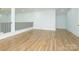 Bright bonus room features hardwood floors, white walls and a black railing at 2008 Plain Field Dr, Bessemer City, NC 28016