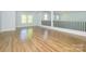 Large bonus room with hardwood floors and neutral colored walls with a black railing at 2008 Plain Field Dr, Bessemer City, NC 28016