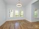 Bright dining room with hardwood floors and natural light from three large windows at 2008 Plain Field Dr, Bessemer City, NC 28016
