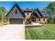 Beautiful two-story home with brick and gray siding, complemented by a well-manicured lawn and a wide driveway at 2008 Plain Field Dr, Bessemer City, NC 28016