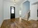 Bright foyer featuring hardwood floors, a staircase with black iron balusters, and modern lighting at 2008 Plain Field Dr, Bessemer City, NC 28016