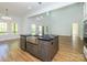 Kitchen island with stainless steel sink, dark cabinetry, marble countertop, and open concept layout at 2008 Plain Field Dr, Bessemer City, NC 28016