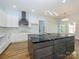 Modern kitchen featuring a large island with dark cabinetry, white countertops, and stainless steel appliances at 2008 Plain Field Dr, Bessemer City, NC 28016