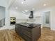 Modern kitchen with a large dark island, white cabinets, stainless steel appliances, and stylish lighting at 2008 Plain Field Dr, Bessemer City, NC 28016